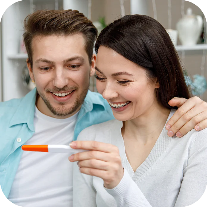 Couple Happily Seeing Pregnancy Test - AAS Fertility